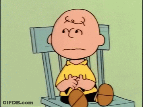 Charlie Brown Is Sitting On A Chair With A Sad Face On His Face . GIF