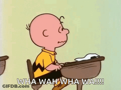 Charlie Brown Sitting At Desk With Hand To Chin GIF