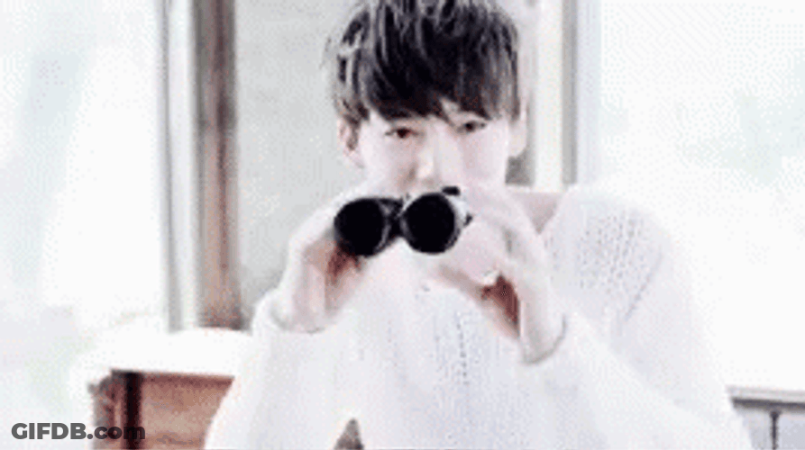 Cheerful Kim Jinwoo Looking Thru Binoculars GIF