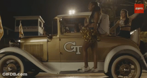 Cheerleader In Front Of Car Saying GT GIF