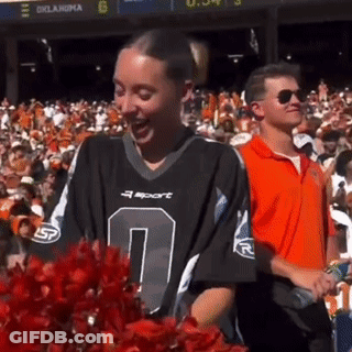 Cheerleader In Number 0 Jersey In Front Of Crowd GIF