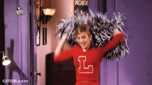 Cheerleader In Red Jersey Holding Pom Poms GIF