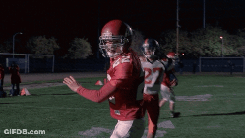 Cheerleader In WMHS Uniform Next To Man In Red Sweater GIF