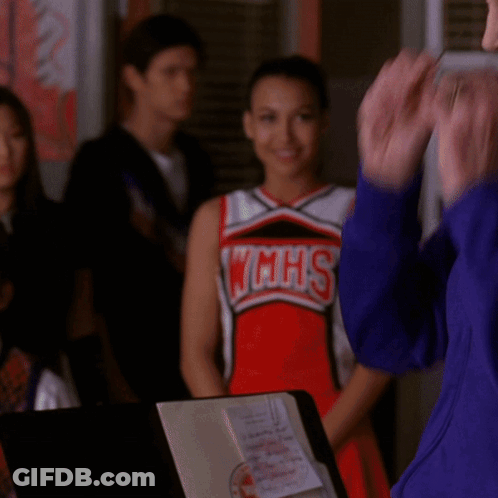 Cheerleader In WMHS Uniform Next To Woman GIF