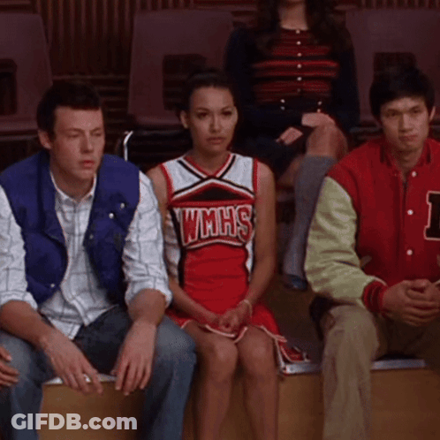 Cheerleader In WMHS Uniform Sitting Next To Man GIF