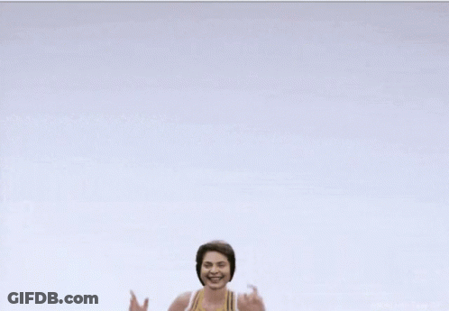 Cheerleader In Yellow And White Top With Letter E GIF