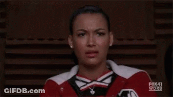 Cheerleader Making Funny Face In Red And White Jacket GIF