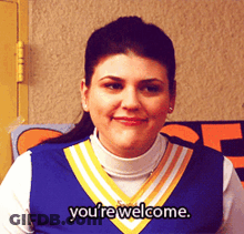 Cheerleader Saying You're Welcome In Front Of Sign GIF