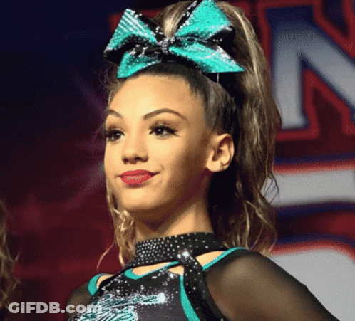 Cheerleader With Bow In Hair Smiling GIF
