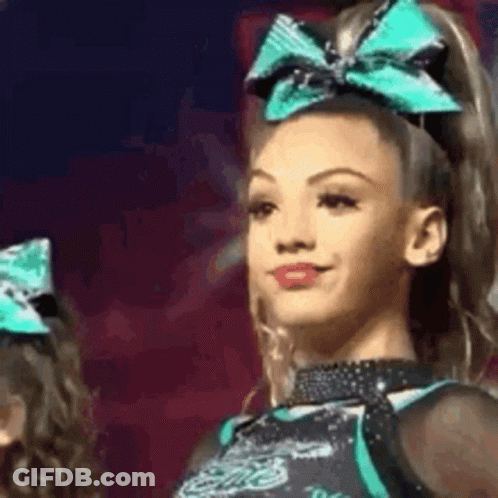Cheerleader With Green Bow Smiling GIF