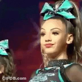 Cheerleader With Green Bow Smiling GIF
