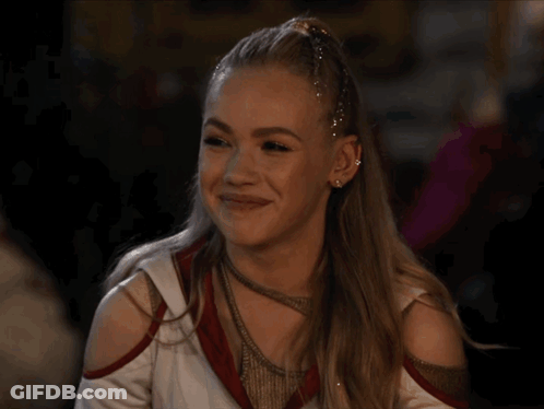 Cheerleader With Ponytail And Earrings Smiling GIF