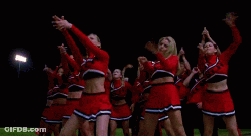 Cheerleaders Dancing In A Field At Night GIF