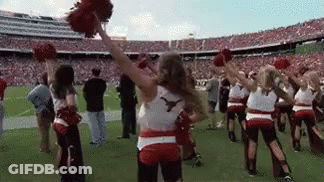 Cheerleaders Holding Pom Poms On Football Field GIF
