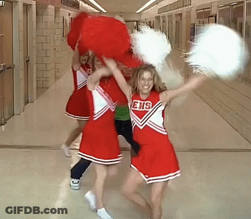 Cheerleaders In Ehs Uniforms Holding Pom Poms In Hallway GIF