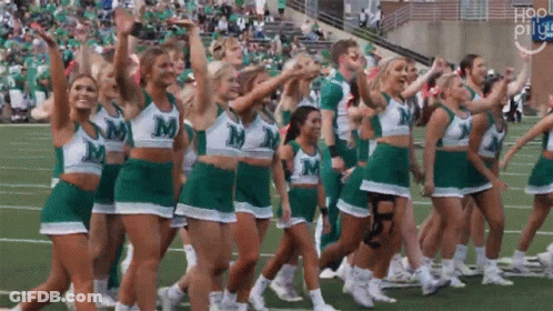 Cheerleaders In Green And White Uniforms With Letter M GIF
