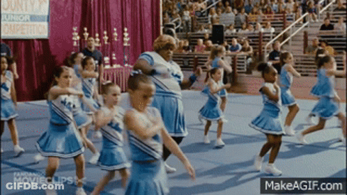 Cheerleaders Performing In Front Of County Junior Sign GIF