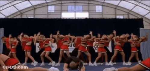 Cheerleaders Performing In Front Of Gil Sign GIF
