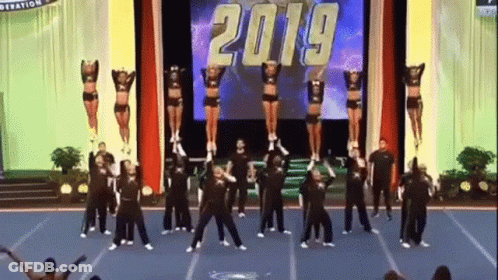 Cheerleaders Performing On Stage In Front Of 2019 Screen GIF
