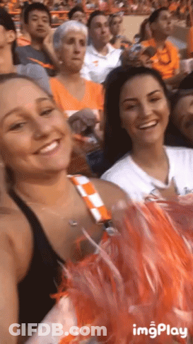Cheerleaders Sitting In Stadium Smiling GIF