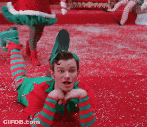 Cheerleaders Smiling With Pom Poms In Locker Room GIF