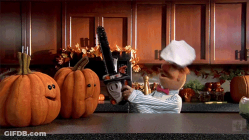 Chef Holding Chainsaw With Two Jack-O'-Lanterns GIF