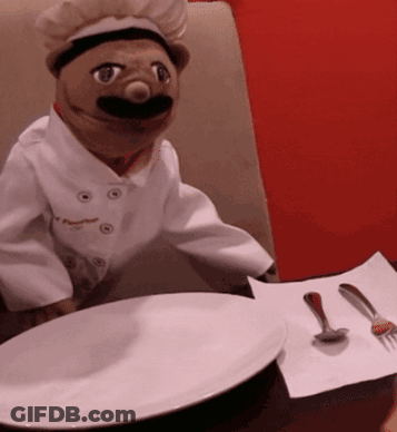 Chef Puppet At Table With Plate And Spoons GIF