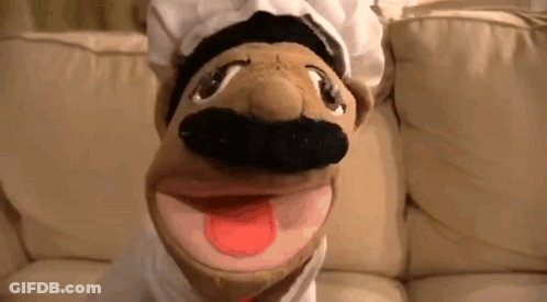 Chef Puppet With Hat And Mustache On Couch Tongue Out GIF
