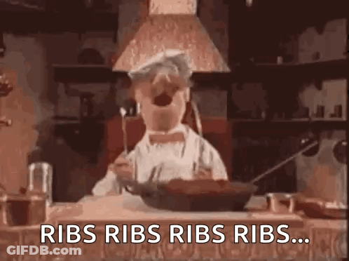 Chef Repeating Ribs While Holding Fork In Mouth GIF