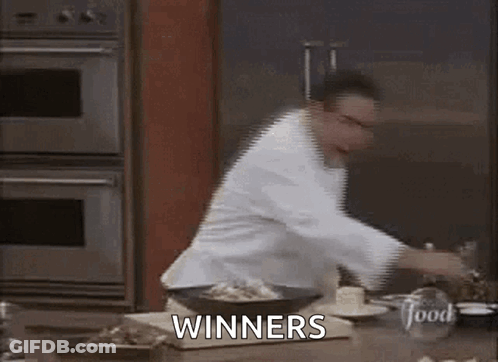 Chef Standing In Kitchen With Winners GIF