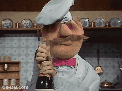 Chef With Pink Bow Tie Holding Bottle GIF