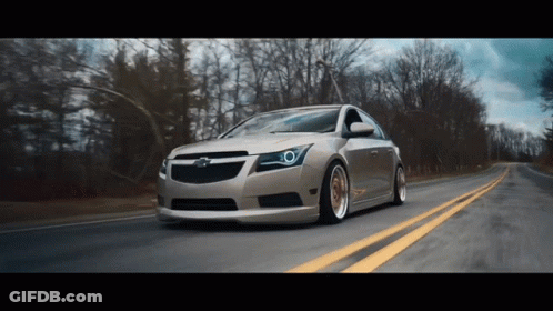 Chevrolet Car Driving Down Road With Trees GIF