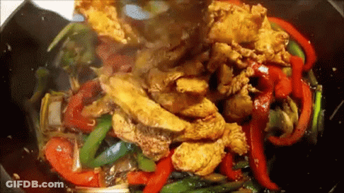 Chicken And Peppers Being Cooked In Wok With Sauce GIF