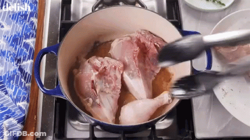Chicken Being Cooked In Pot On Stove With Tongs GIF