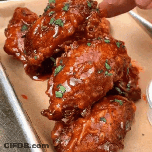 Chicken Wing Dipped In Sauce With Herbs GIF