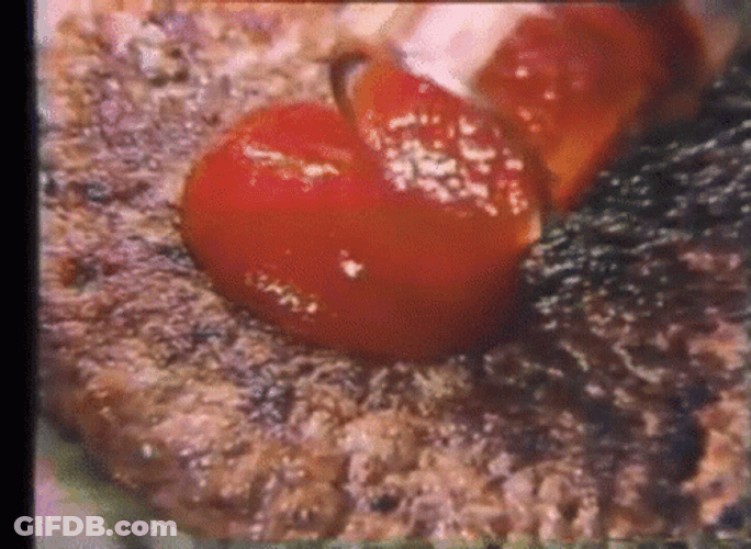 Child Adding Ketchup To Meatloaf GIF