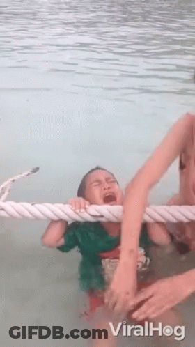 Child Crying In Water Pulled By Rope GIF