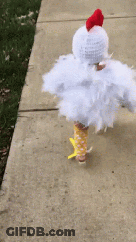 Child Dressed As Chicken Walking Down Sidewalk GIF