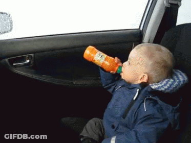 Child Drinking Orange Juice In Car GIF