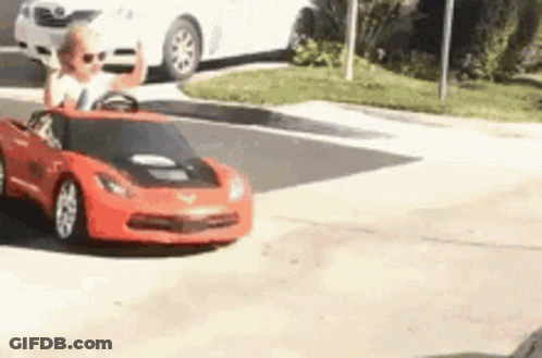Child Driving Red Toy Car GIF