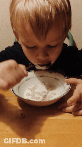 Child Eating Cereal With Spoon GIF