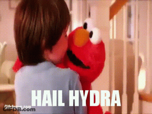 Child Hugging Elmo From Sesame Street GIF