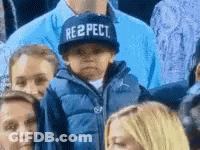 Child In Respect Hat Sitting In Crowd GIF