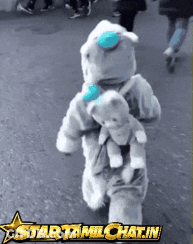 Child In Teddy Bear Costume Holding Teddy Bear GIF