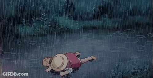 Child Laying On Ground In Rain GIF