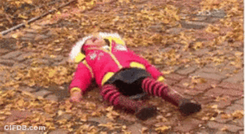 Child Lying In Leaves GIF