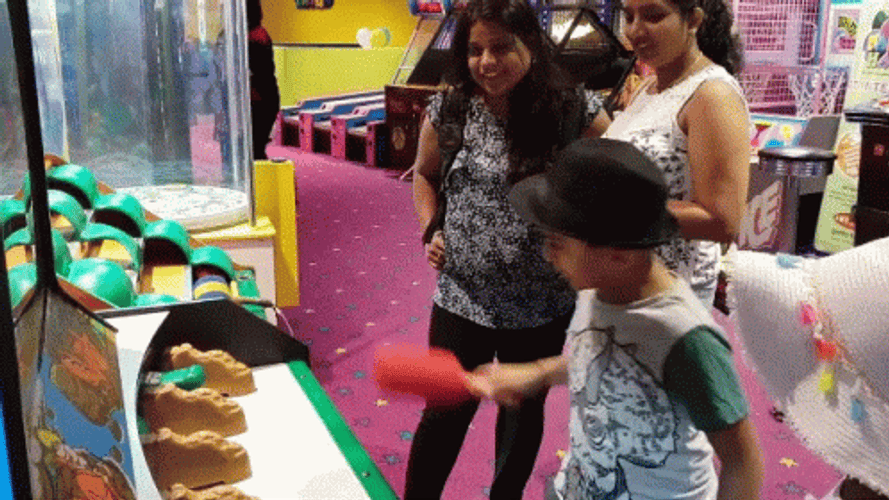 Child Playing Whack A Mole GIF