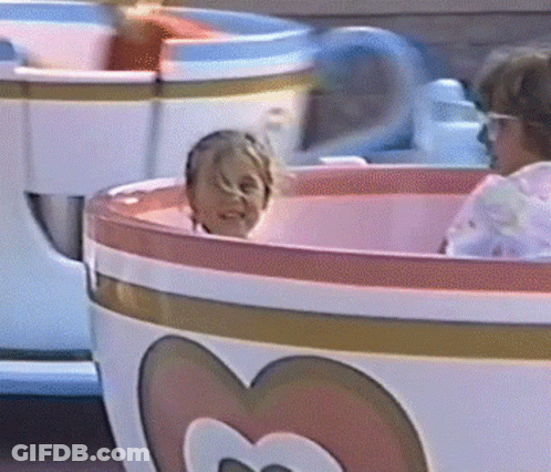 Child Riding Pink And White Tea Cup With Heart GIF