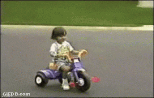 Child Riding Purple Tricycle GIF