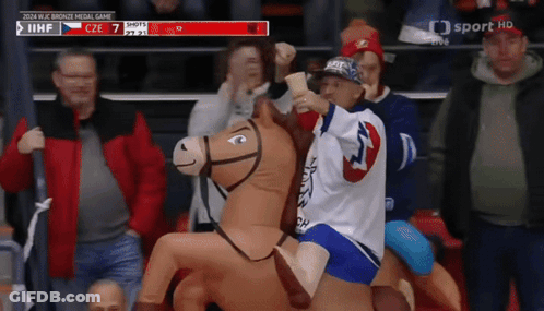 Child Riding Stuffed Horse At Hockey Game GIF